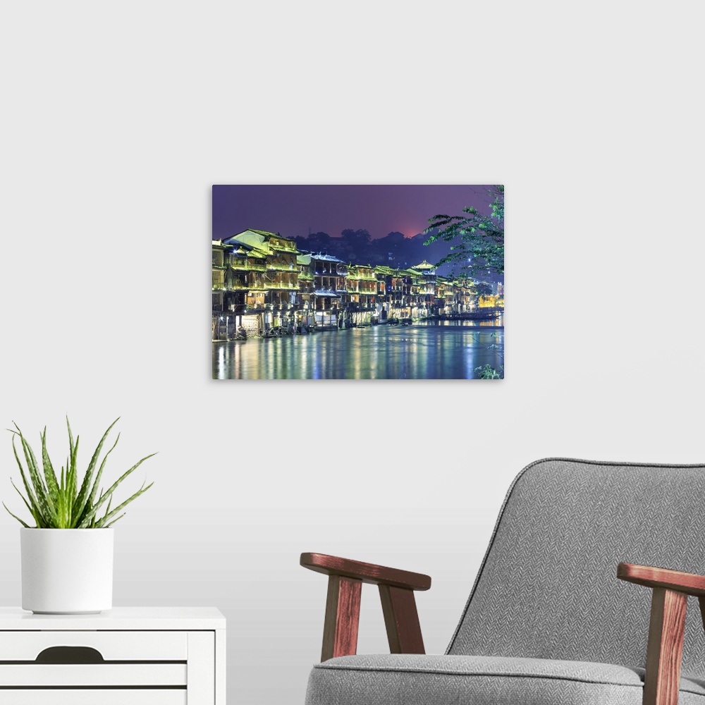 A modern room featuring China, Hunan province, Fenghuang, riverside houses.