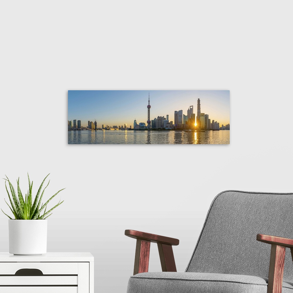 A modern room featuring China, Shanghai, Pudong District, Skyline of the Financial District across Huangpu River at sunrise