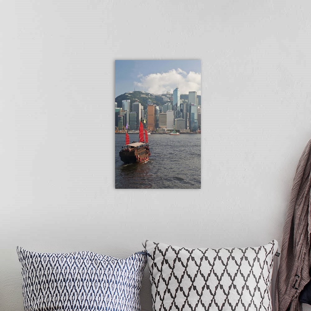 A bohemian room featuring One of the last remaining Chinese sailing junks on Victoria Harbour, Hong Kong, China, Asia, view...