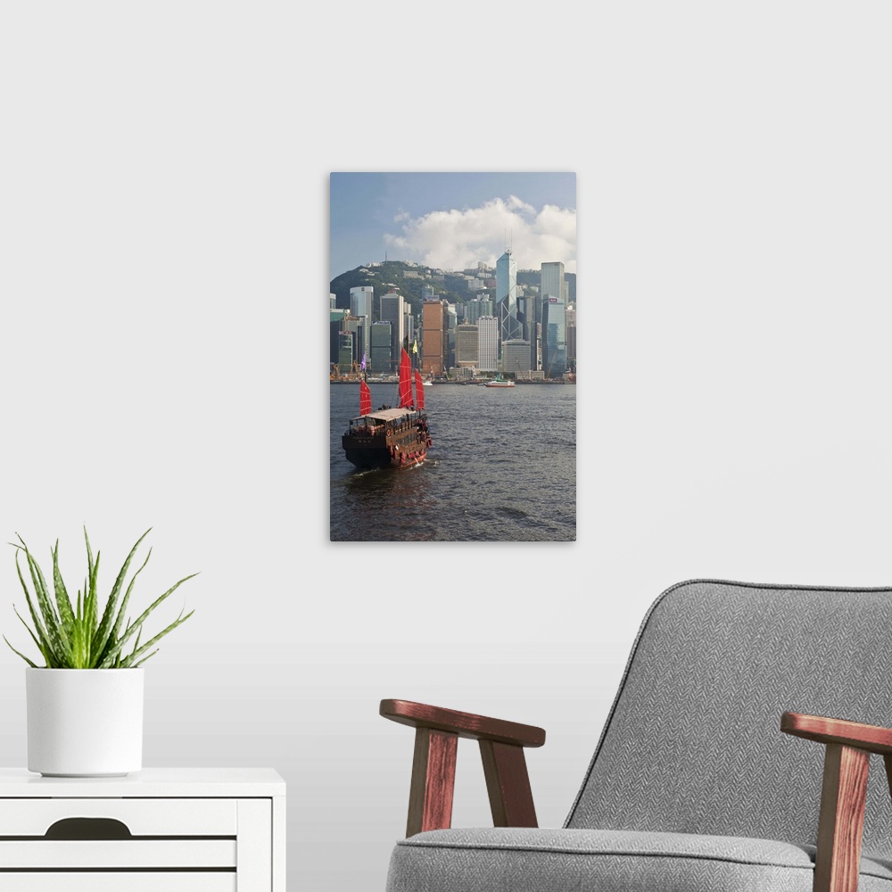 A modern room featuring One of the last remaining Chinese sailing junks on Victoria Harbour, Hong Kong, China, Asia, view...