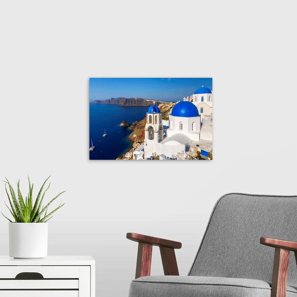 A modern room featuring Church with blue domes in Oia, Santorini, South Aegean, Greece