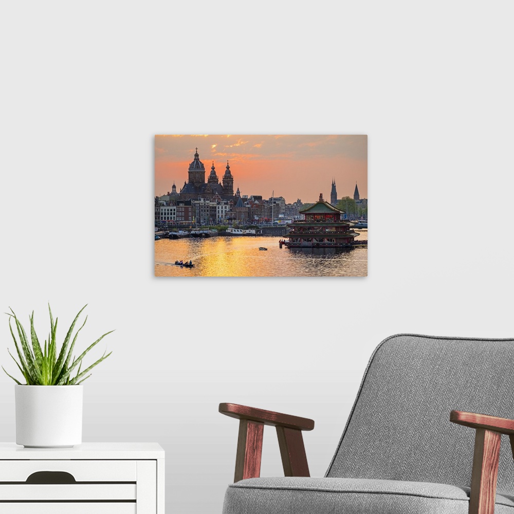 A modern room featuring Netherlands, North Holland, Amsterdam. City skyline at sunset with domes of Basilica of Saint Nic...