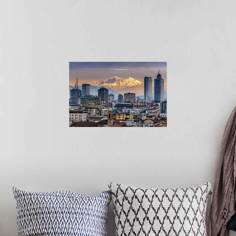 A bohemian room featuring City skyline at sunset with the snowy Alps in the background, Milan, Lombardy, Italy