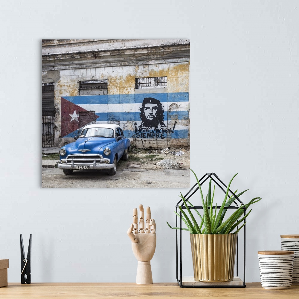 A bohemian room featuring Classic American car and Cuban flag, Habana Vieja, Havana, Cuba.