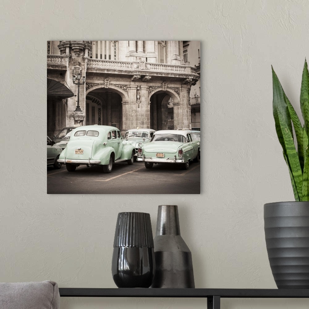 A modern room featuring Classic American Cars in front of the Gran Teatro, Parque Central, Havana, Cuba