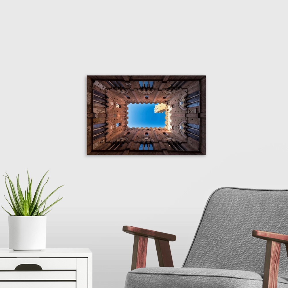 A modern room featuring Siena, Tuscany, Italy, Europe. Classic Bottom View Of Palazzo Pubblico With Del Mangia's Tower At...