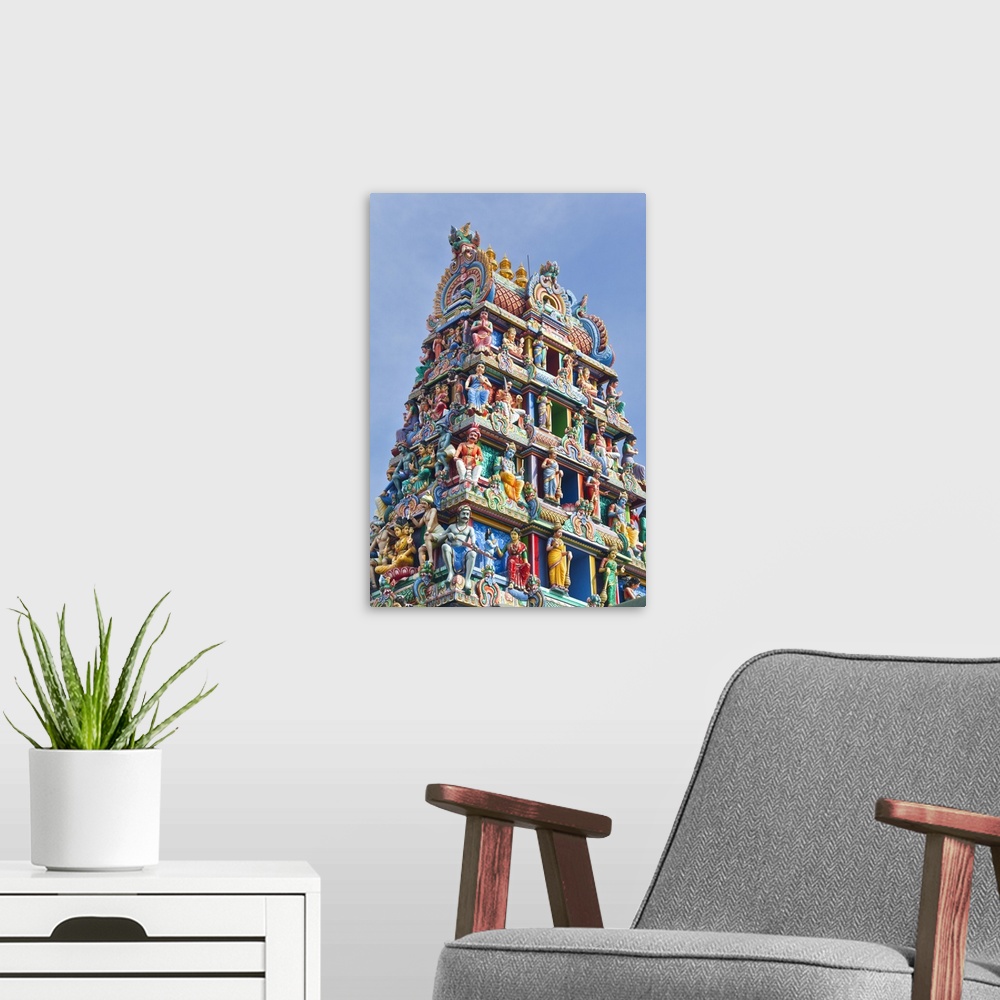 A modern room featuring Close up of the Gopuram of the Sri Mariamman Temple in Singapore. A Dravidian style temple in Sin...