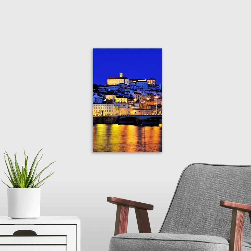 A modern room featuring Coimbra and the Mondego river at sunset. Portugal
