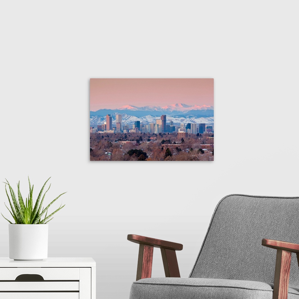 A modern room featuring USA, Colorado, Denver, city view and Rocky Mountains from the east, dawn