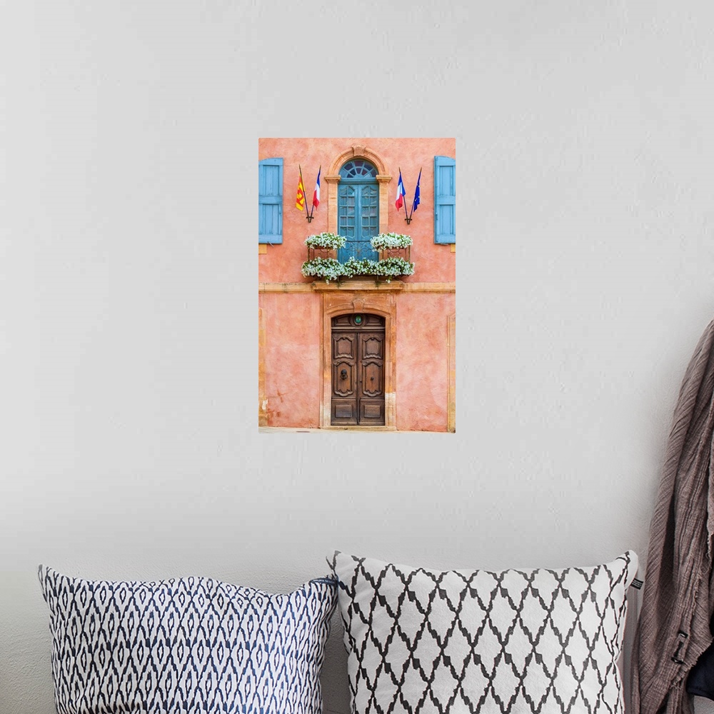 A bohemian room featuring Colorful ochre colored facade of Mairie (mayor's office) in Roussillon, Vaucluse, Provence-Alpes-...