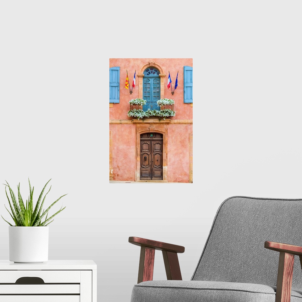 A modern room featuring Colorful ochre colored facade of Mairie (mayor's office) in Roussillon, Vaucluse, Provence-Alpes-...
