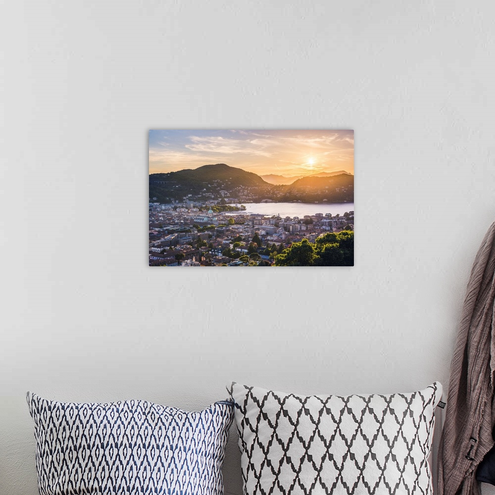 A bohemian room featuring Como, Lombardy, Italy. High angle view over the city and the Como Cathedral at sunset.