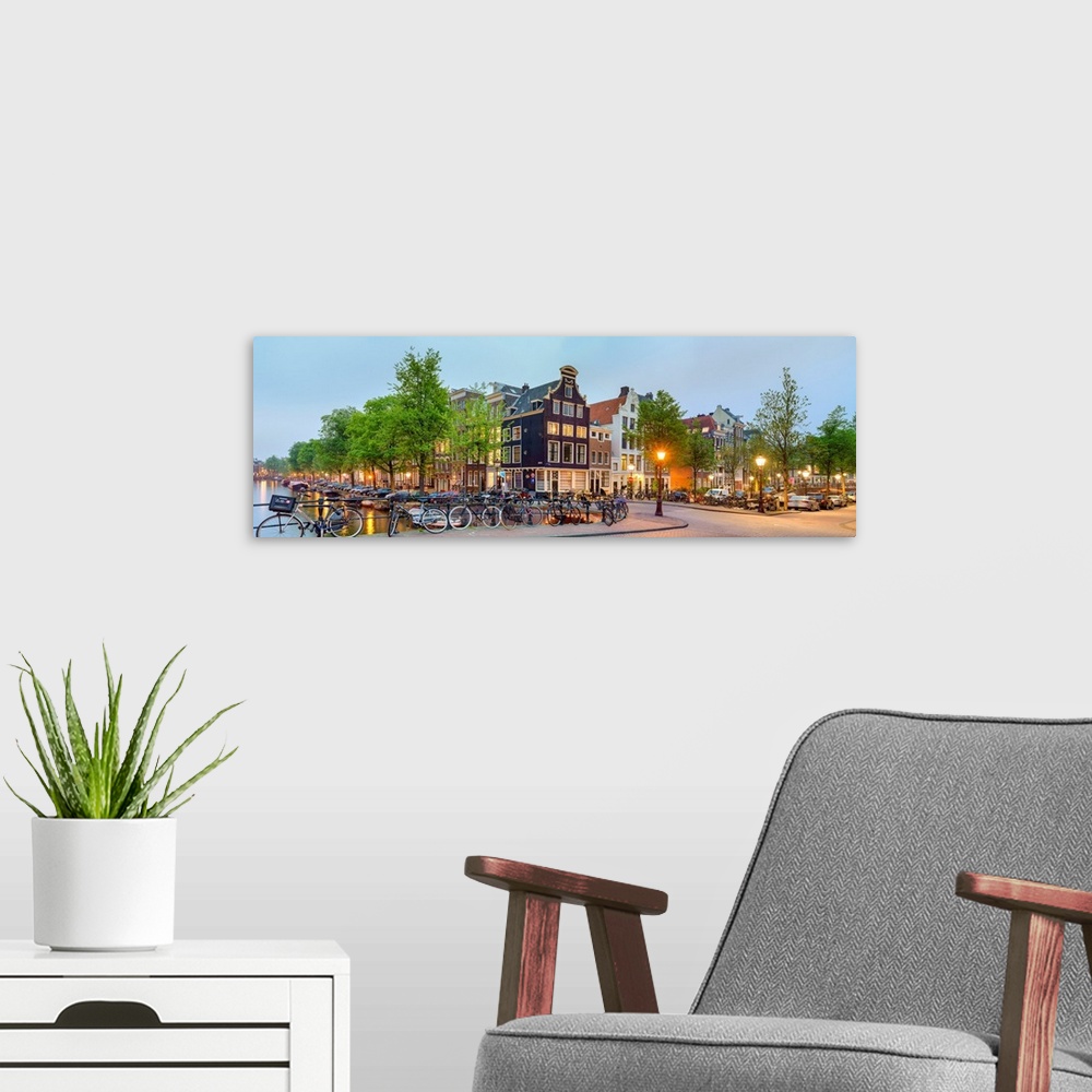 A modern room featuring Corner of Prinsengracht and Blauwburgwal at night, Amsterdam, North Holland, Netherlands.