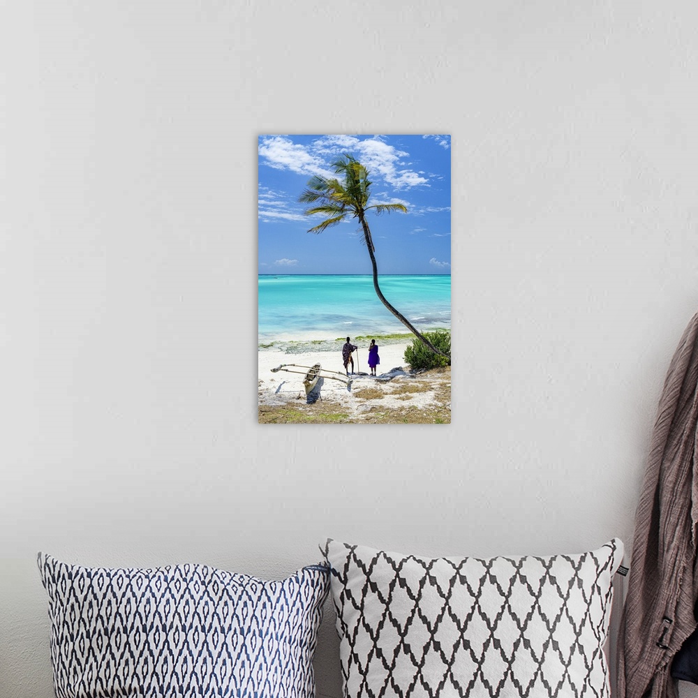 A bohemian room featuring Couple of Maasai with dhow admiring the crystal sea standing on a palm fringed beach, Zanzibar, T...