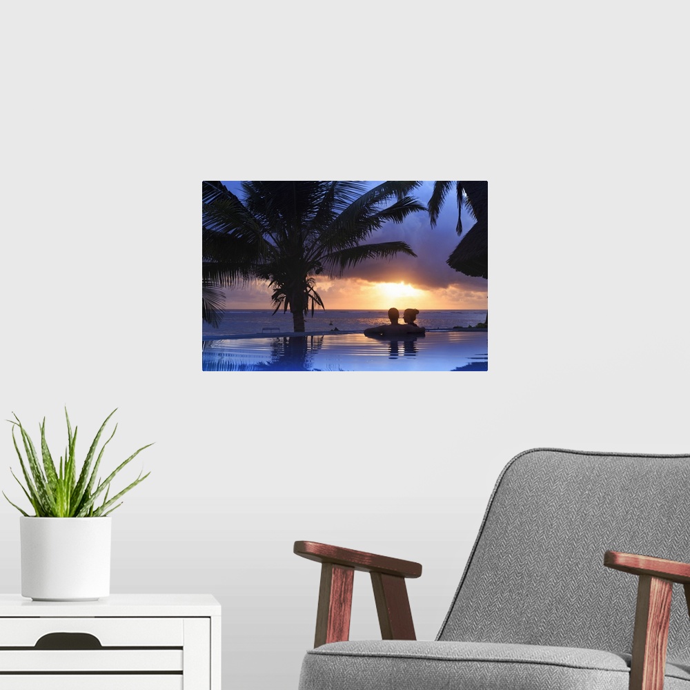 A modern room featuring Tanzania. Zanzibar, Kigomani, Couple relaxing inside infinity pool overlooking the beach at luxur...