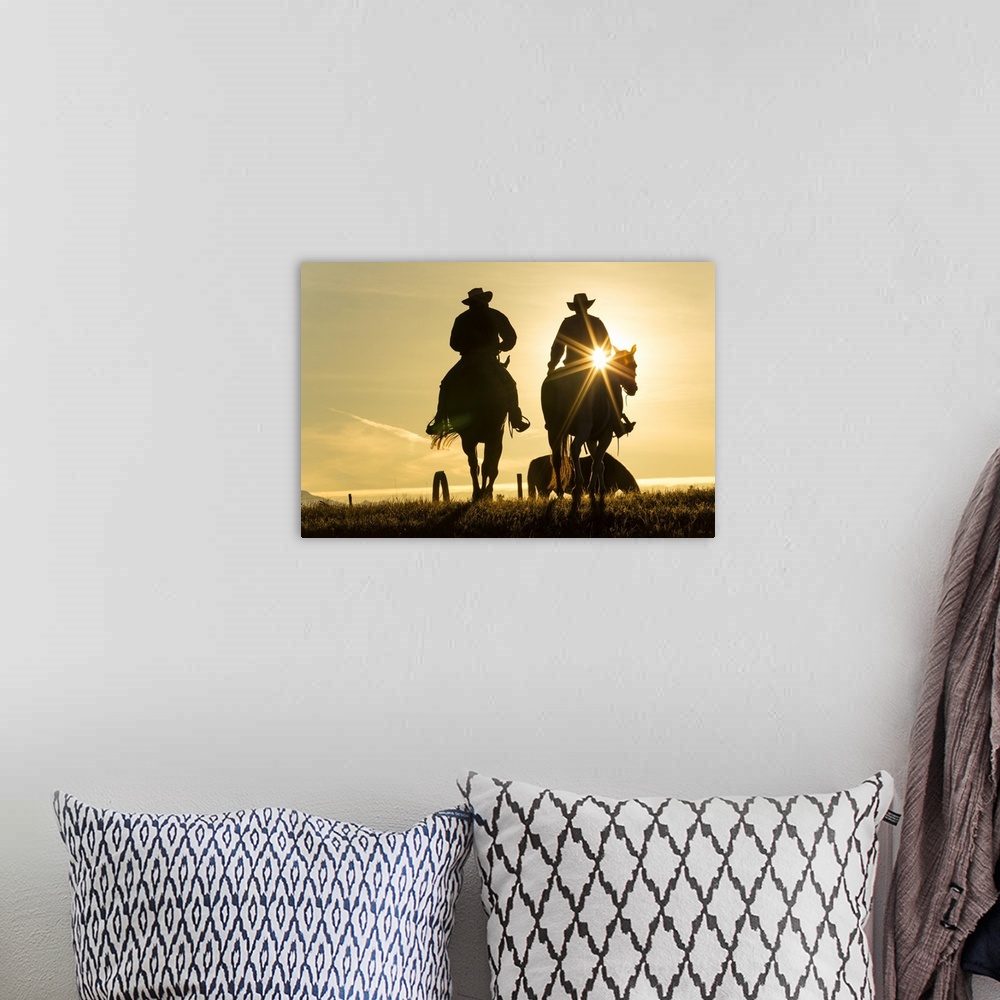 A bohemian room featuring Cowboys on horses, sunrise, British Colombia, Canada.