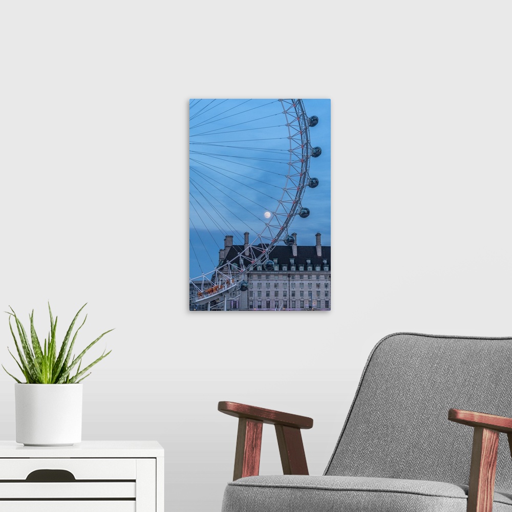 A modern room featuring Details of London Eye ferris wheel with County Hall in background under the full moon, London, Un...