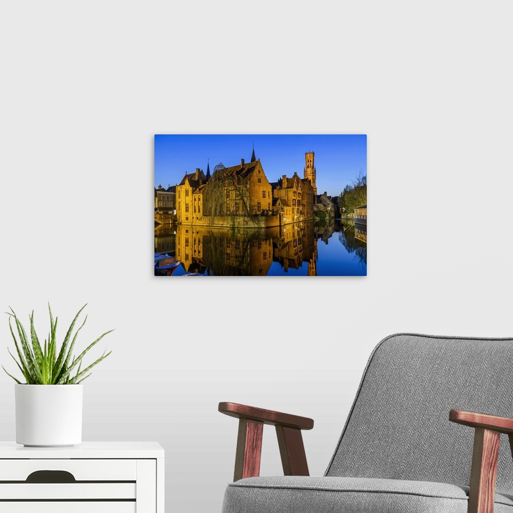 A modern room featuring Dijver canal with Belfort medieval tower in the background, Bruges, West Flanders, Belgium