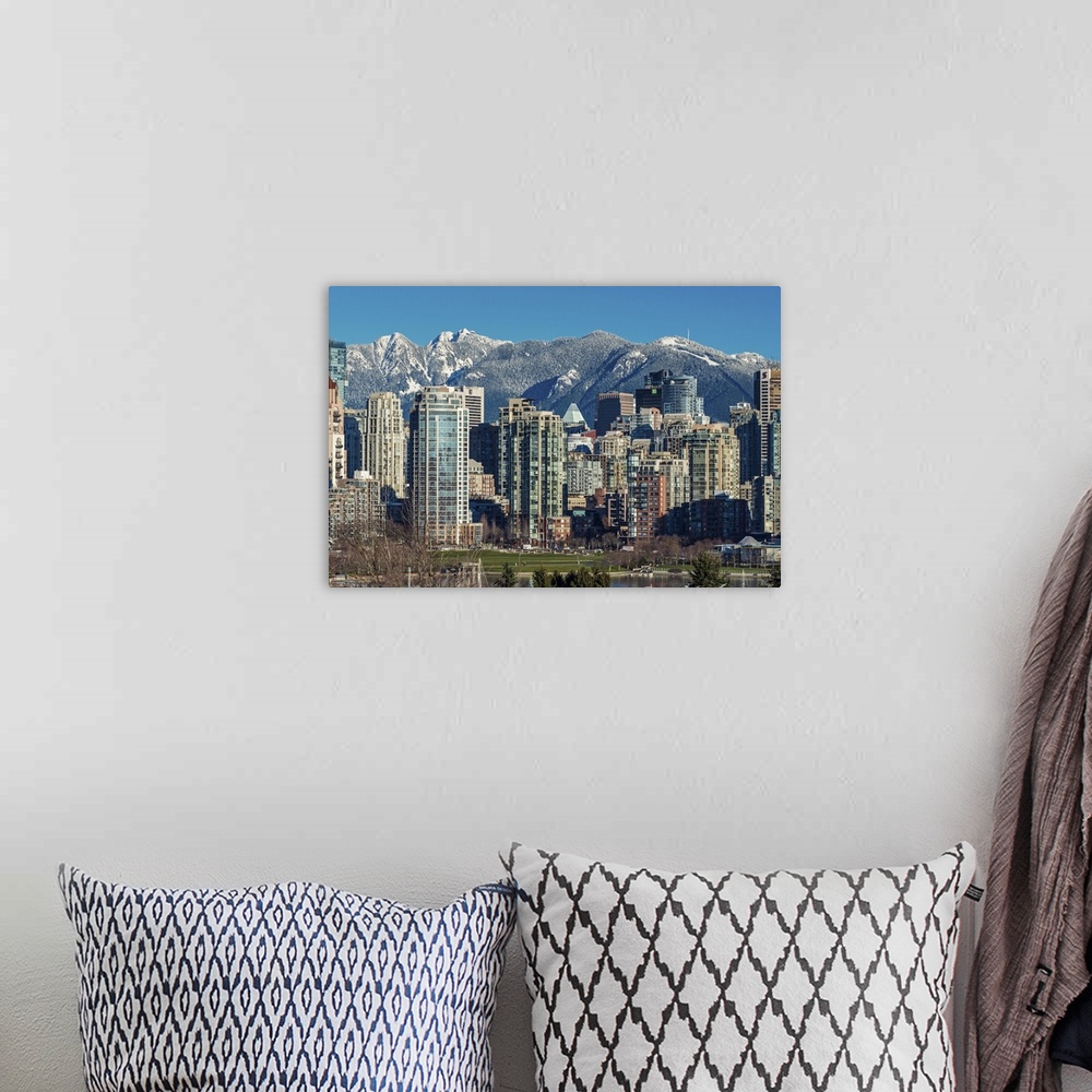 A bohemian room featuring Downtown skyline with snowy mountains behind, Vancouver, British Columbia, Canada.