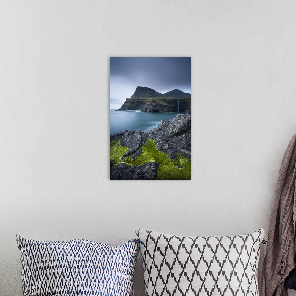 A bohemian room featuring Dramatic coastline and waterfall at Gasadalur on the Island of Vagar, Faroe Islands. Spring