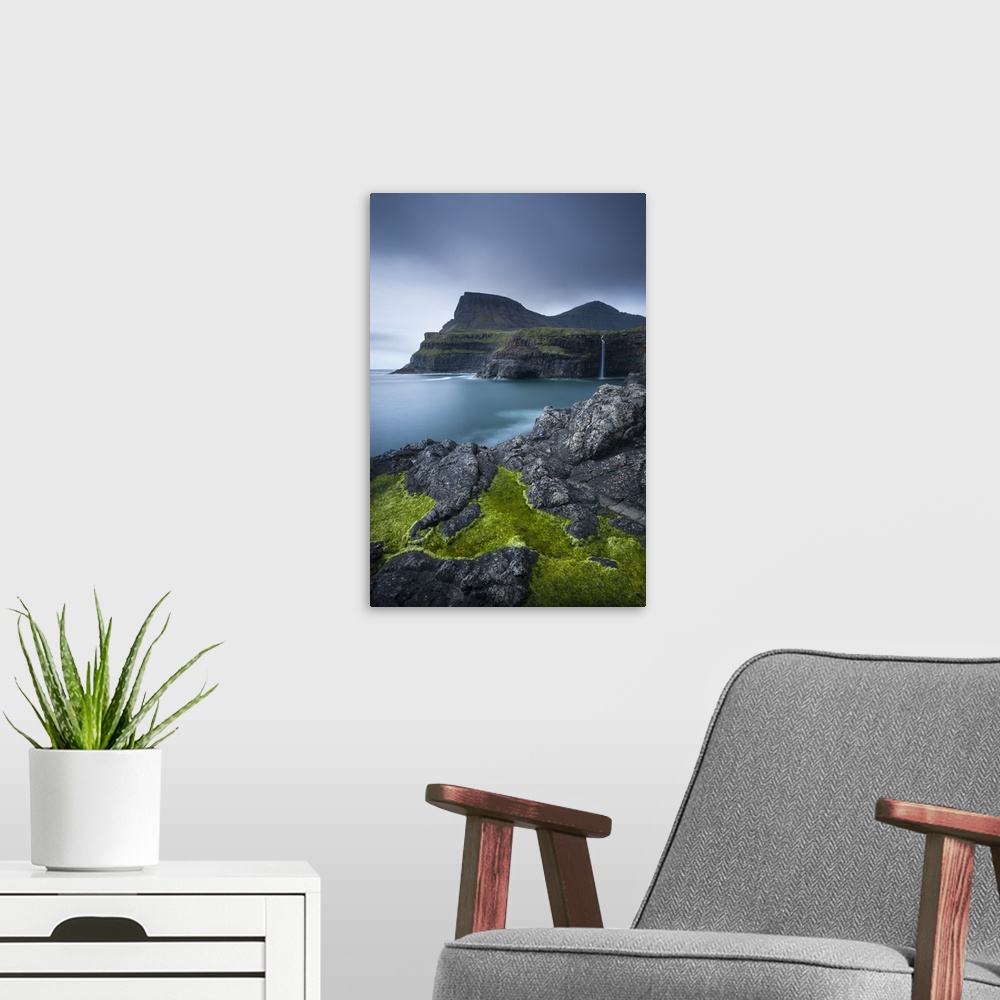 A modern room featuring Dramatic coastline and waterfall at Gasadalur on the Island of Vagar, Faroe Islands. Spring