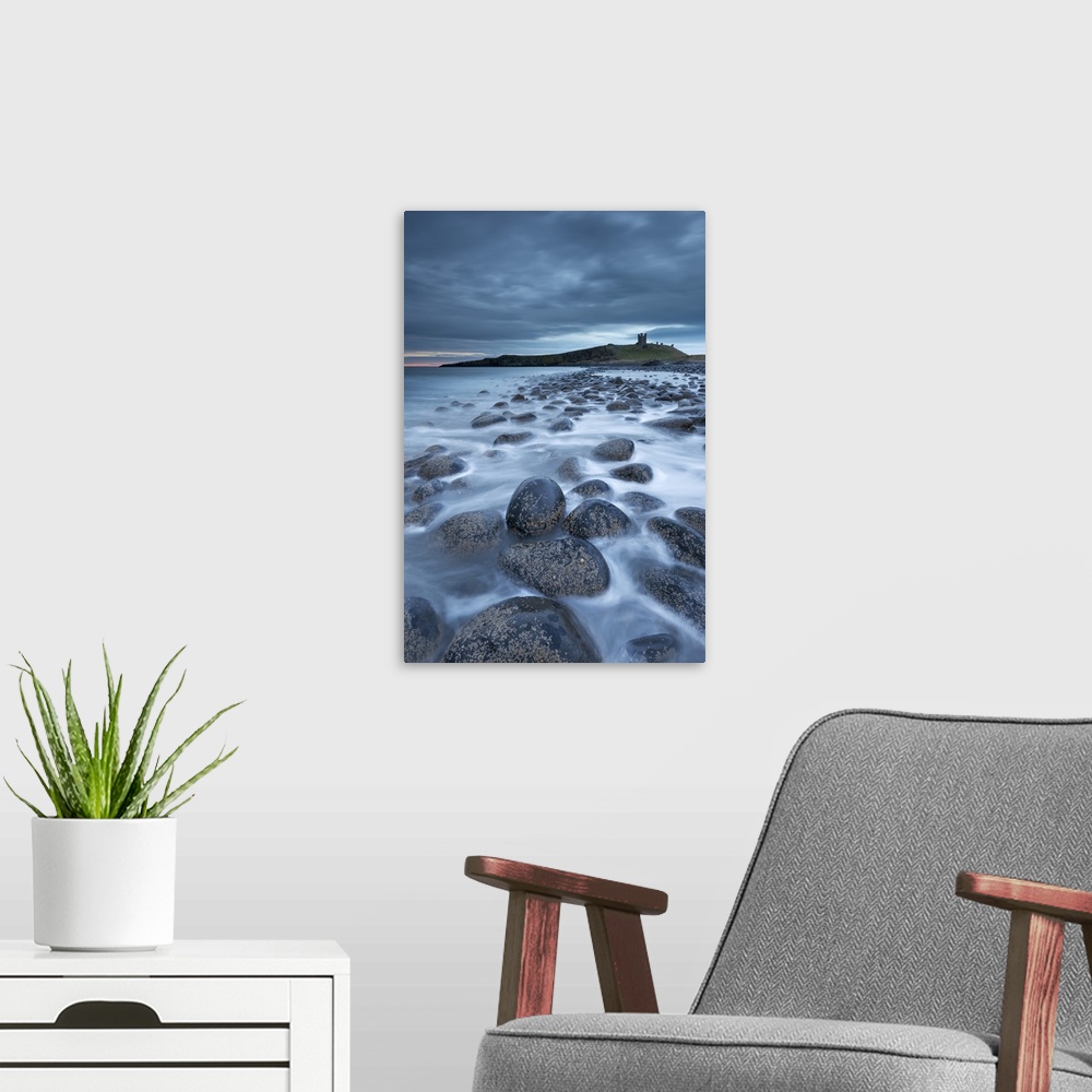 A modern room featuring Dunstanburgh Castle at dawn from Embleton Bay, Northumberland, England. Spring (April)
