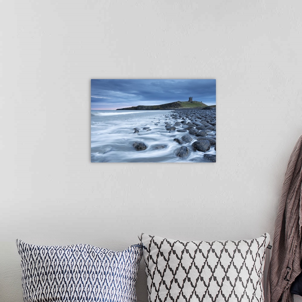 A bohemian room featuring The ruins of Dunstanburgh Castle overlooking the boulder strewn shores of Embleton Bay, Northumbe...