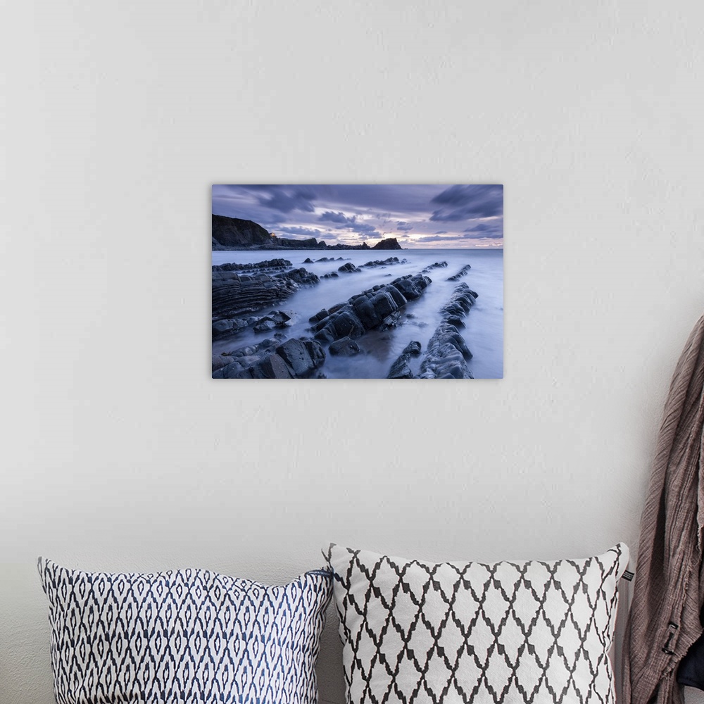 A bohemian room featuring Dusk over the rugged ledges of Hartland Quay in North Devon, England.