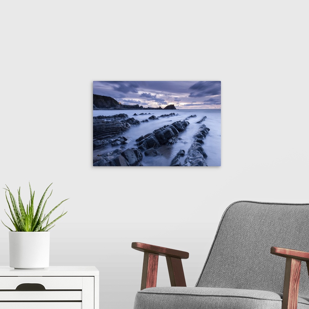 A modern room featuring Dusk over the rugged ledges of Hartland Quay in North Devon, England.