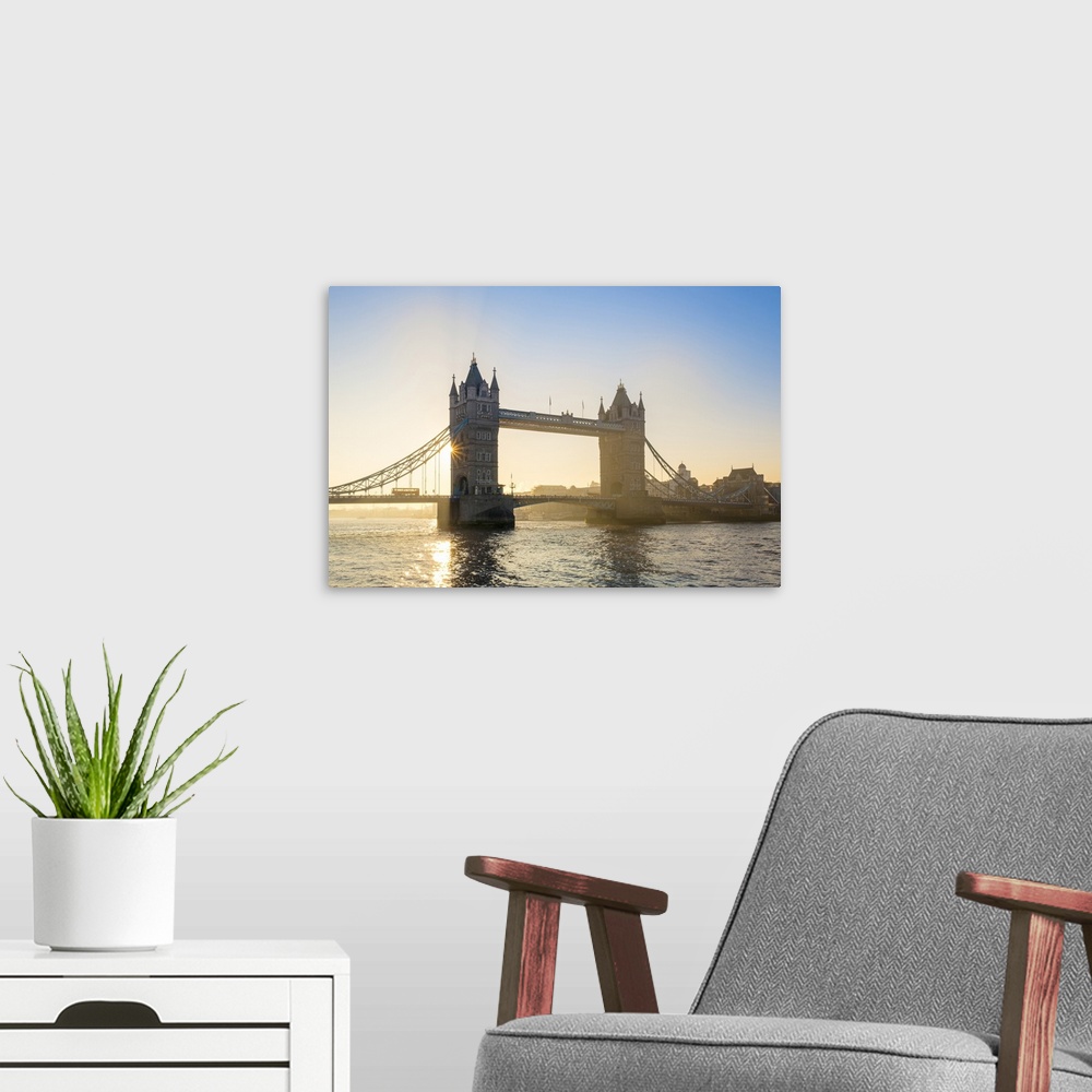 A modern room featuring United Kingdom, England, London. Early morning sun rising behind Tower Bridge over the River Thames.