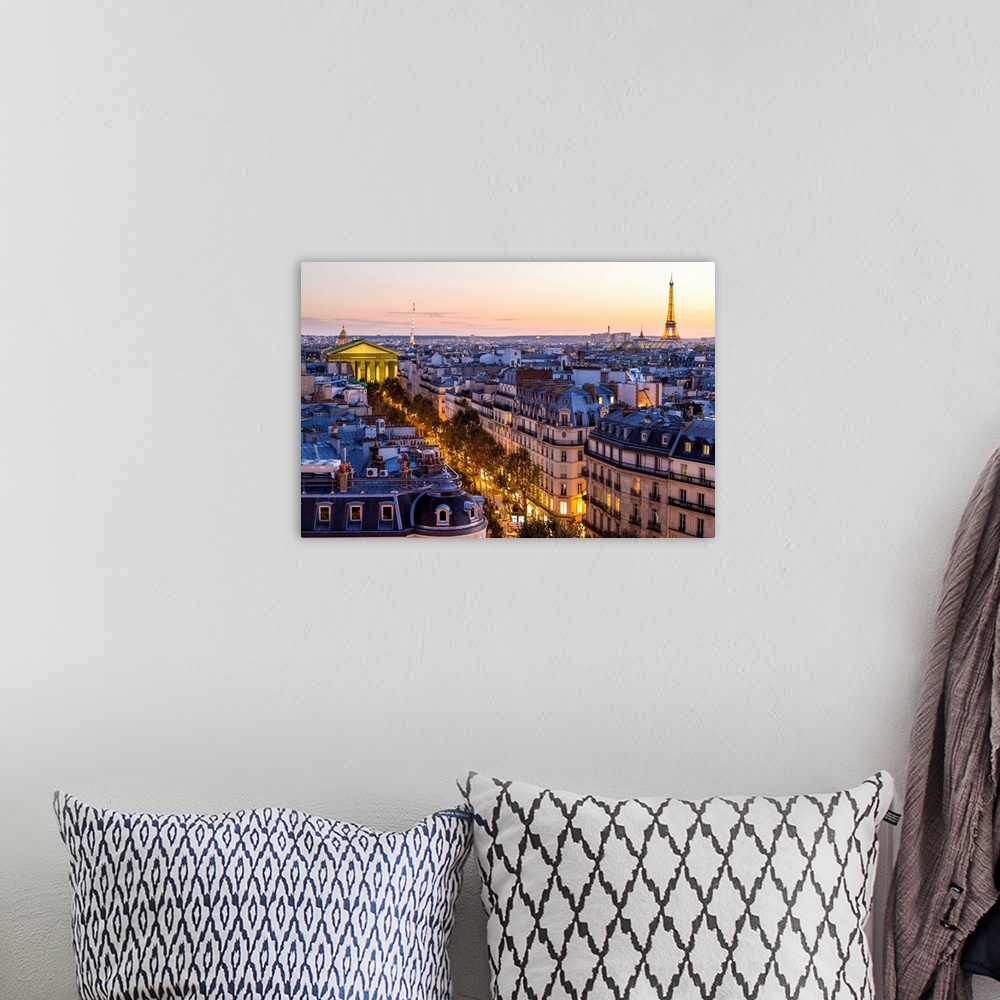 A bohemian room featuring Eiffel Tower and Paris skyline at dusk, Paris, France.
