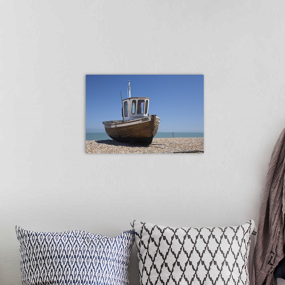 A bohemian room featuring England, Kent, Deal. Old wooden fishing boat on the shingle beach at Deal.