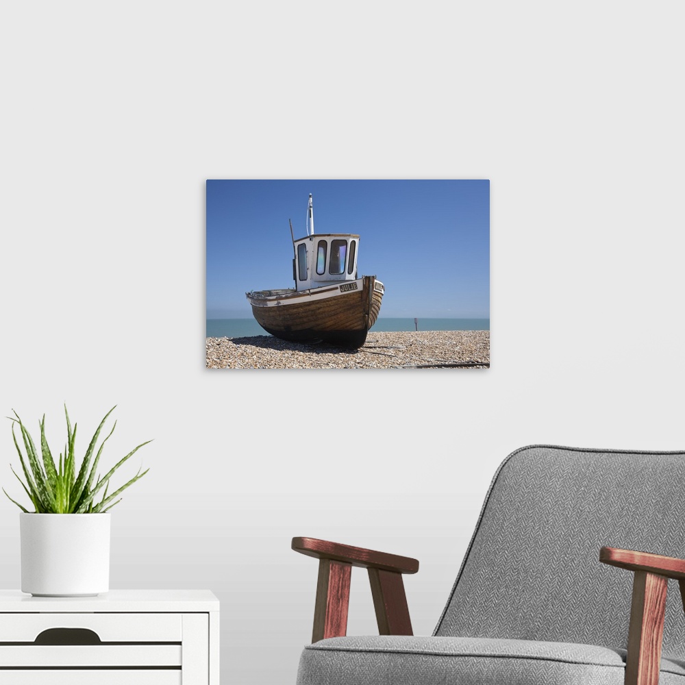 A modern room featuring England, Kent, Deal. Old wooden fishing boat on the shingle beach at Deal.