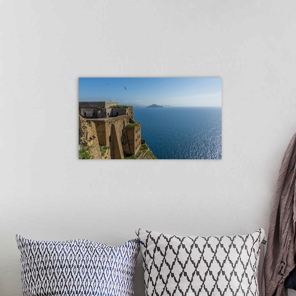 A bohemian room featuring Europe, Italy, Campania. The palazzo D'Avalos of Procida seen with Capri Island in the background.