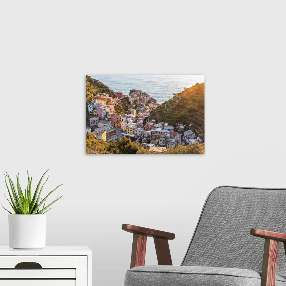 A modern room featuring Europe, Italy, Liguria. View over the Cinque Terre village Manarola at sunset