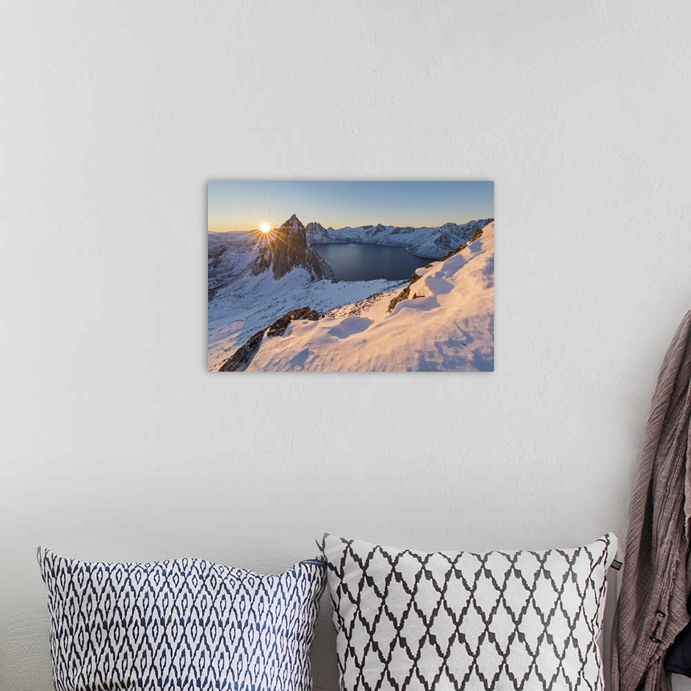 A bohemian room featuring First lights of sunrise on Mount Segla and Mefjorden framed by the frozen sea seen from peak Hest...