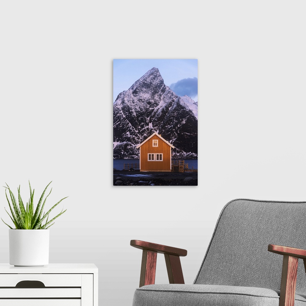 A modern room featuring Fishermen's cabin (rorbu) of Sakrisoy along the coast at sunrise in the Lofoten islands, Norway