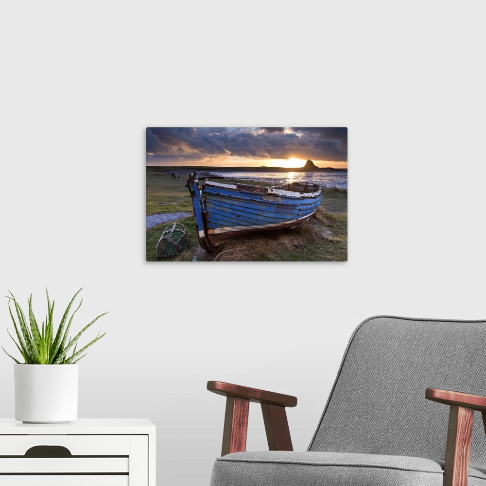 A modern room featuring Decaying fishing boat on Holy Island at dawn, with Lindisfarne Castle beyond, Northumberland, Eng...