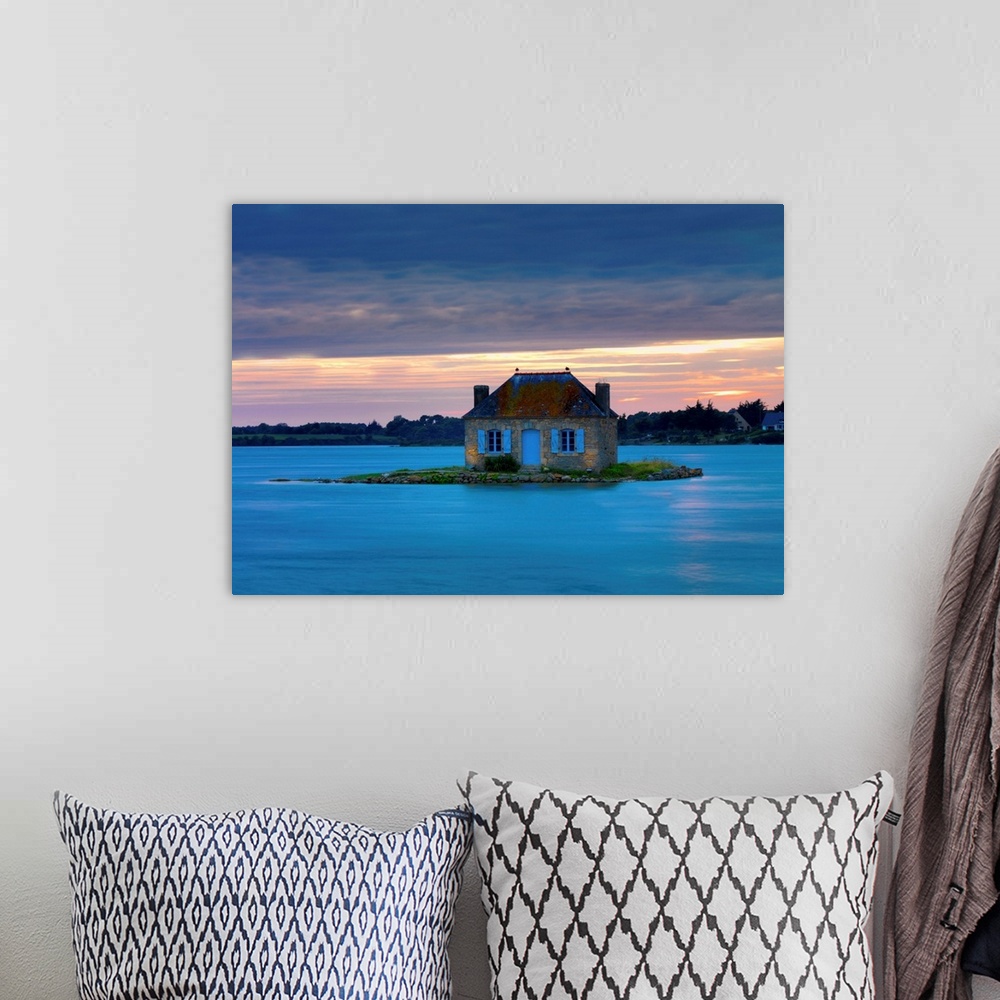 A bohemian room featuring France, Brittany, Morbihan, Belz, Etel river, St. Cado, house on the island of Nichtarguer at dusk.