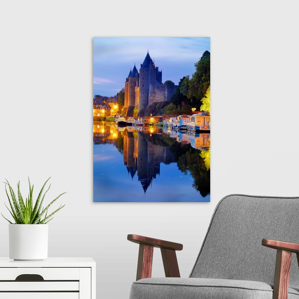 A modern room featuring France, Brittany, Morbihan, Josselin, Chateau de Rohan castle on the Oust River at night.