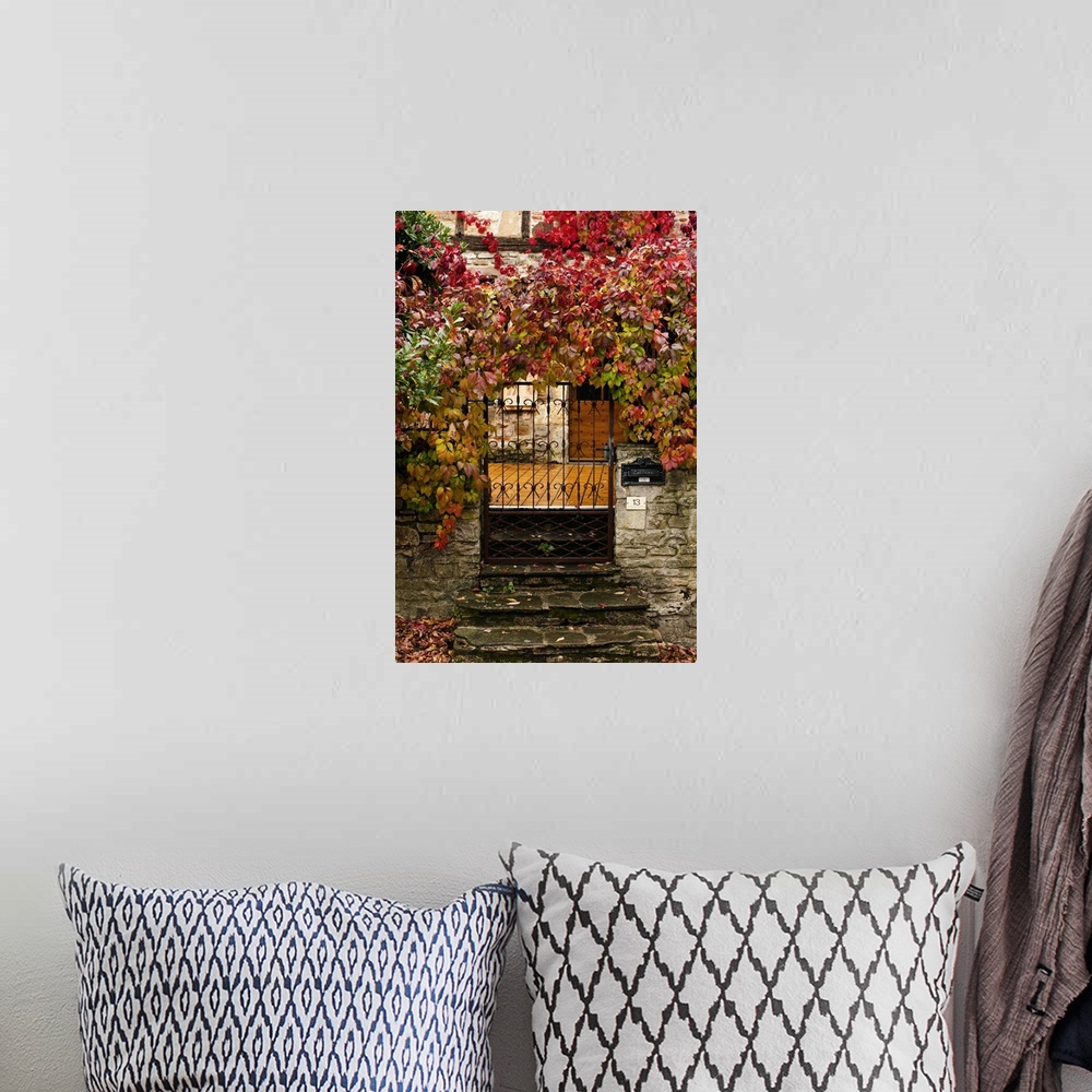 A bohemian room featuring France, Midi-Pyrenees Region, Tarn Department, Cordes-sur-Ciel, gate with autumn foliage