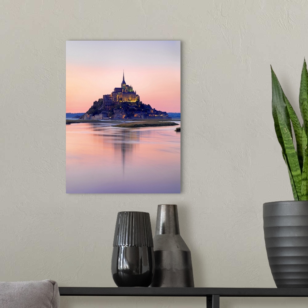 A modern room featuring France, Normandy, Le Mont Saint Michel reflected in river at night.