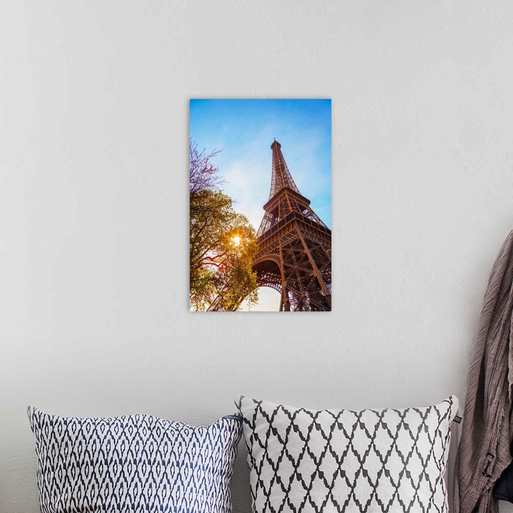 A bohemian room featuring France, Paris, Eiffel Tower, sun behind tree.