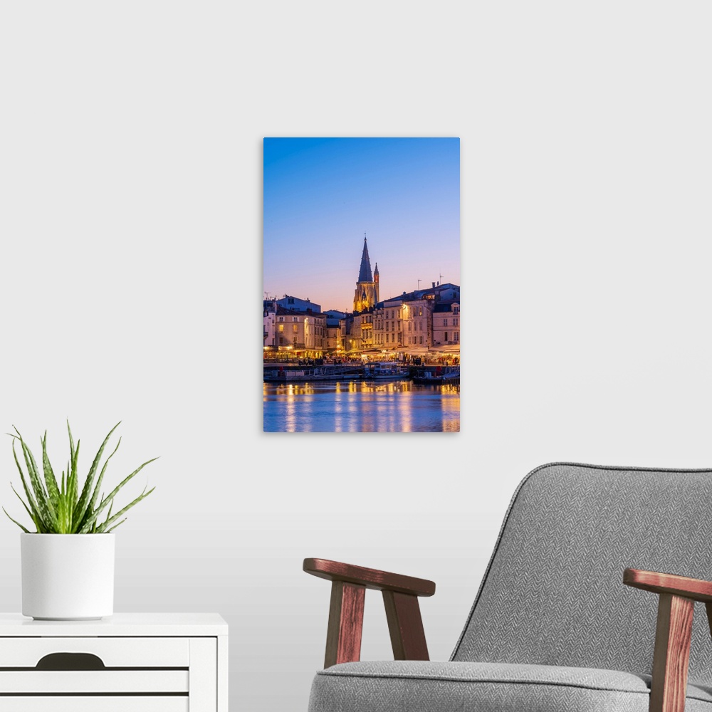A modern room featuring France, Poitou Charentes, La Rochelle, Old Harbour and lantern tower at dusk.