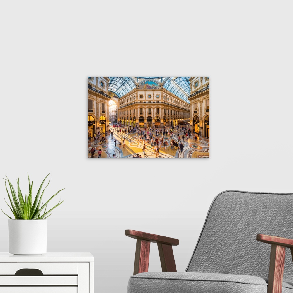 A modern room featuring Galleria Vittorio Emanuele II, Milan, Lombardy, Italy. Tourists walking in the world's oldest sho...