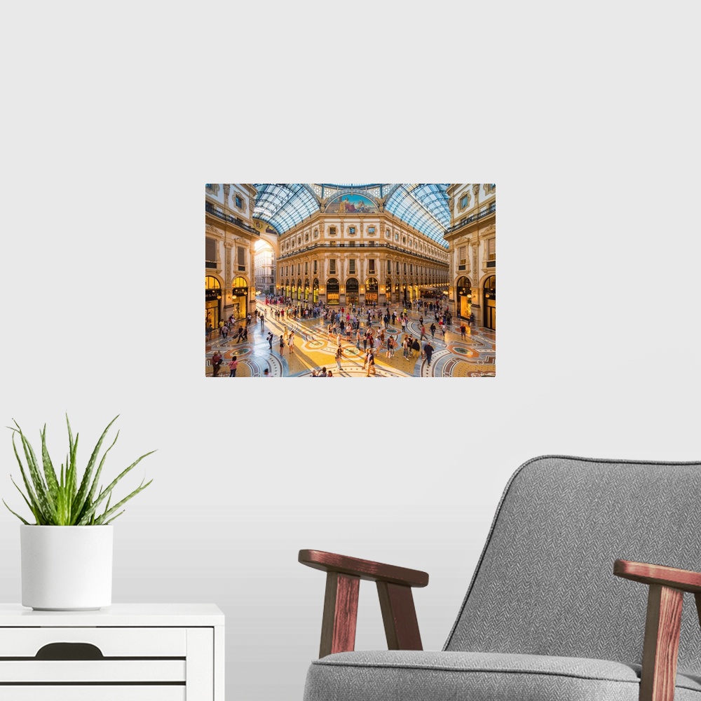 A modern room featuring Galleria Vittorio Emanuele II, Milan, Lombardy, Italy. Tourists walking in the world's oldest sho...