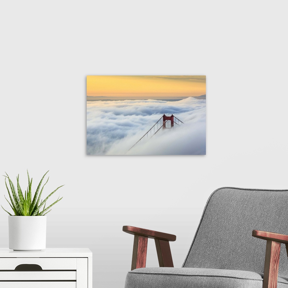 A modern room featuring Golden Gate Bridge emerging from the morning fog at sunrise. San Francisco, Marin County, Califor...