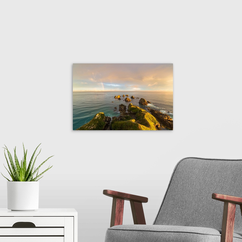 A modern room featuring Golden light on The Nuggets islands and rainbow in the sky at Nugget Point. Ahuriri Flat, Clutha ...