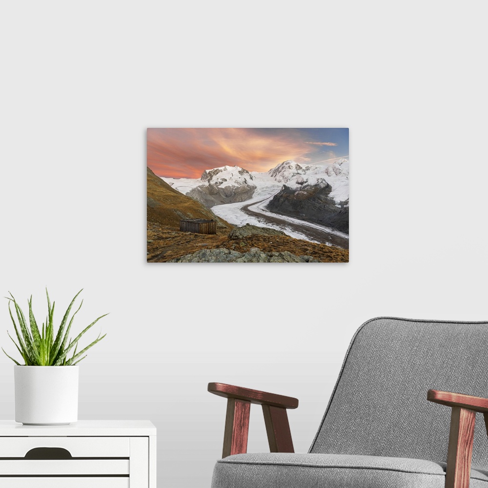 A modern room featuring Gorner glacier with the Monte Rosa massif and Lyskamm peaks at dusk, Zermatt, Valais canton, Swit...