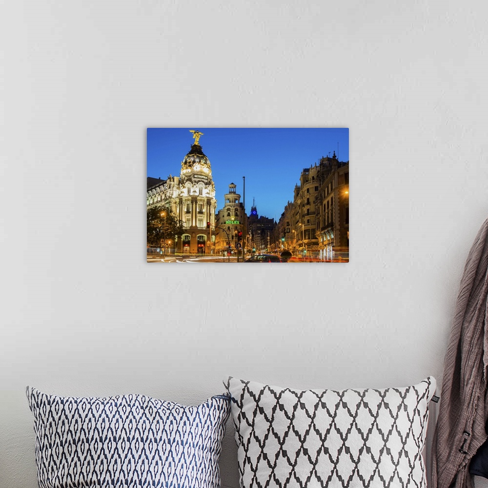 A bohemian room featuring Night view of Gran Via street and Metropolis Building with car light trails, Madrid, Comunidad de...